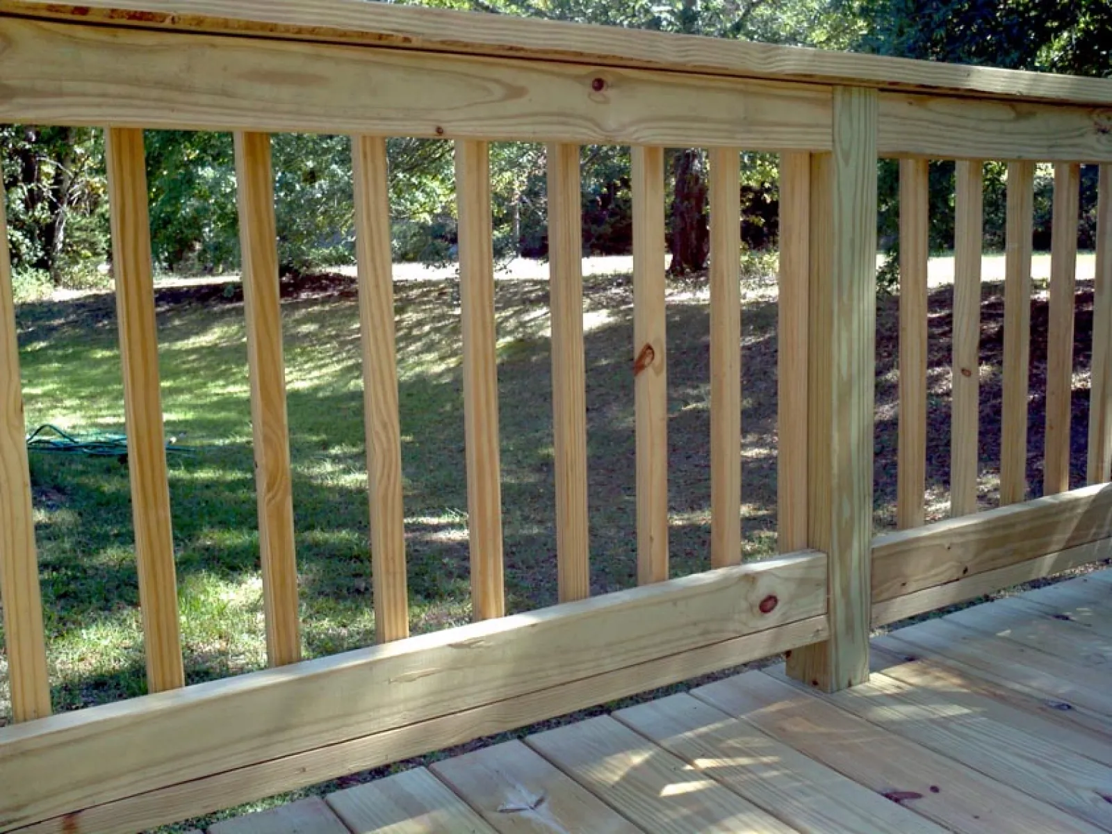 a wooden deck with a railing