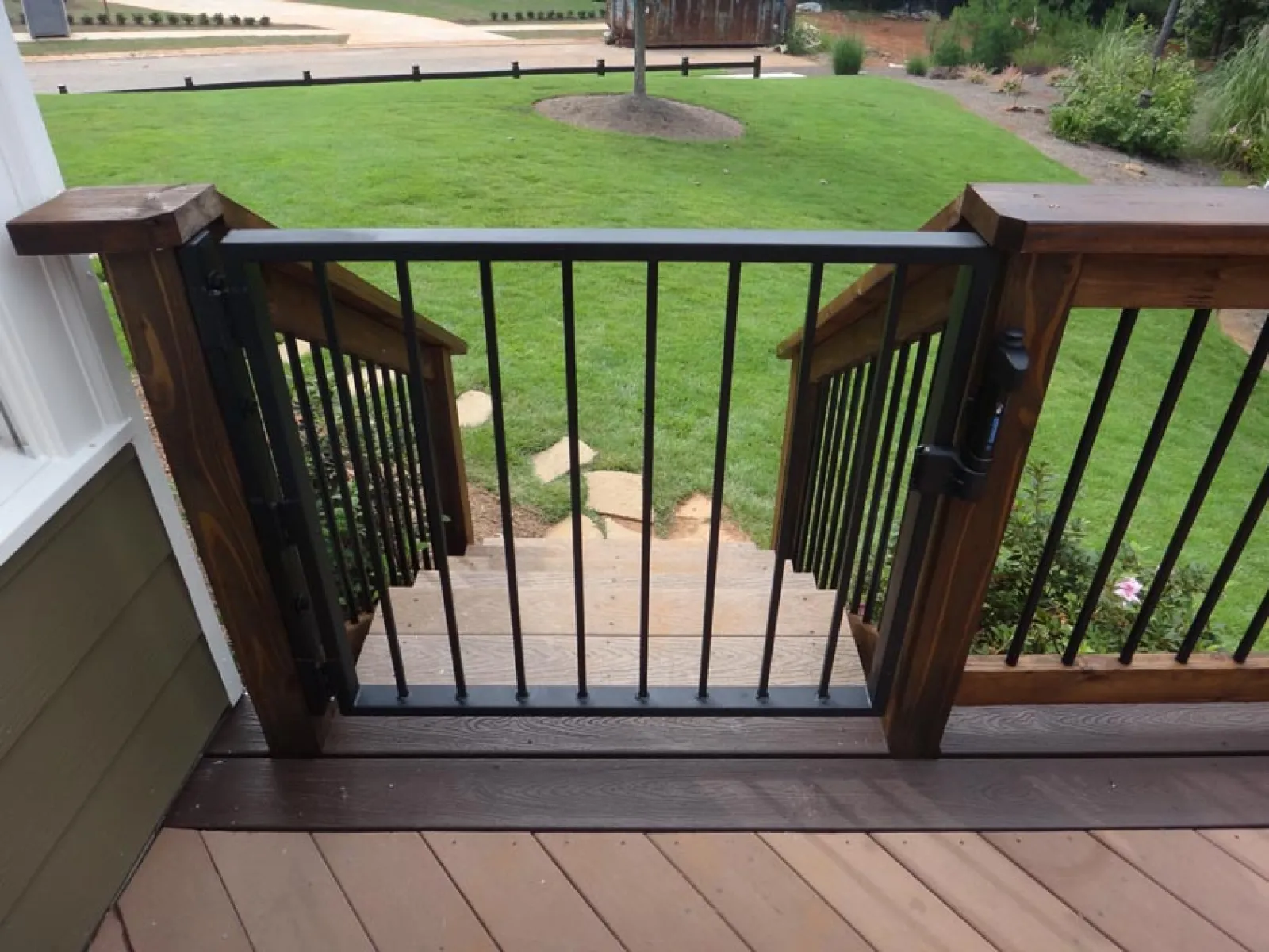 a deck with a railing and grass