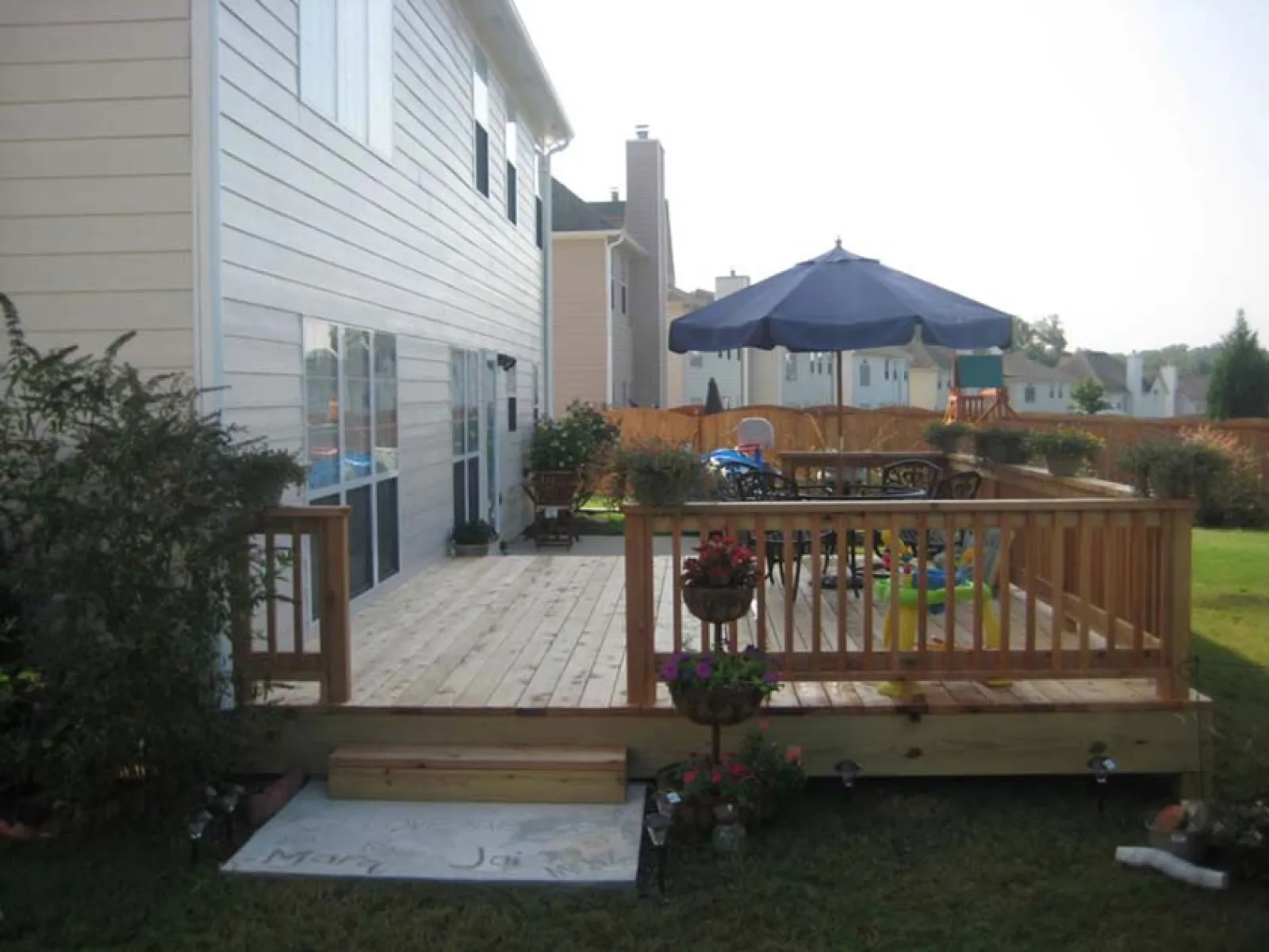 a deck with a table and umbrella