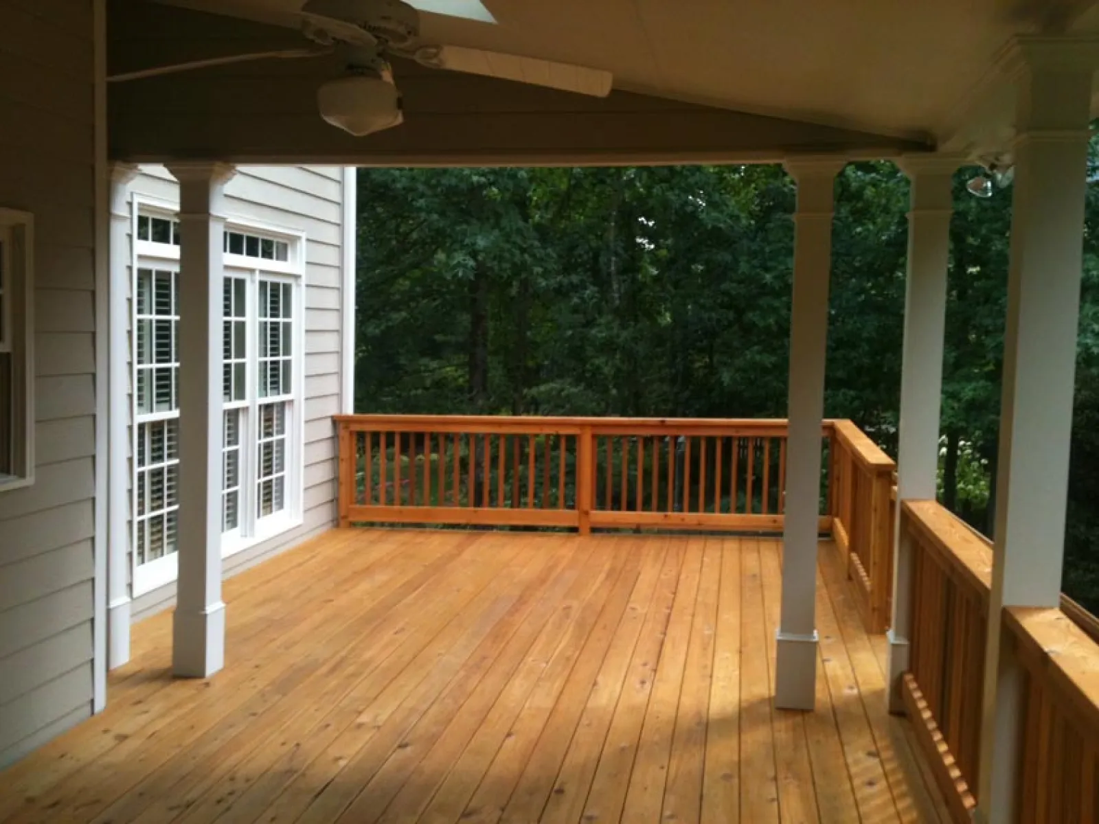 a wooden deck with a railing and a wood railing