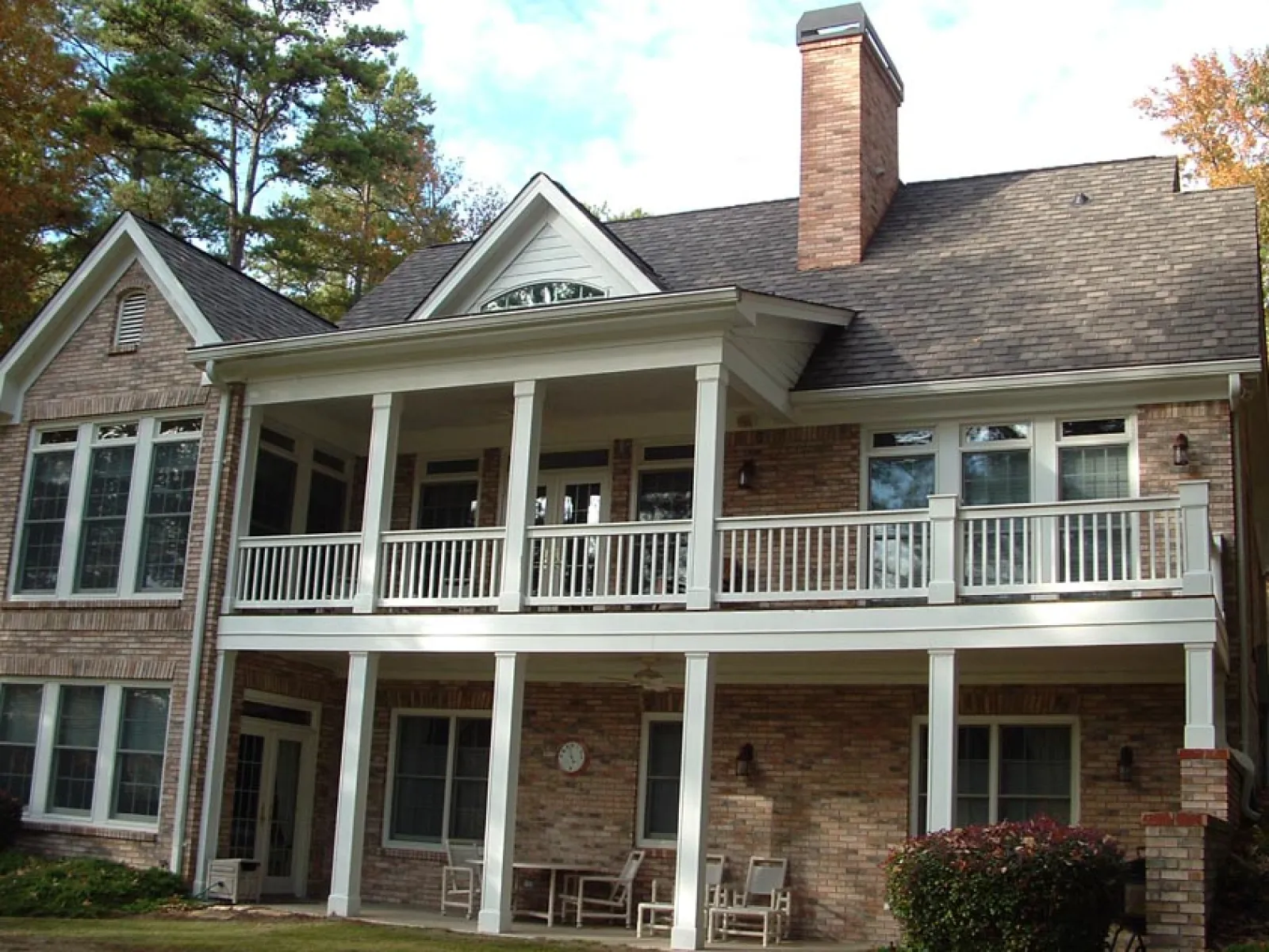 a large brick house with a white porch