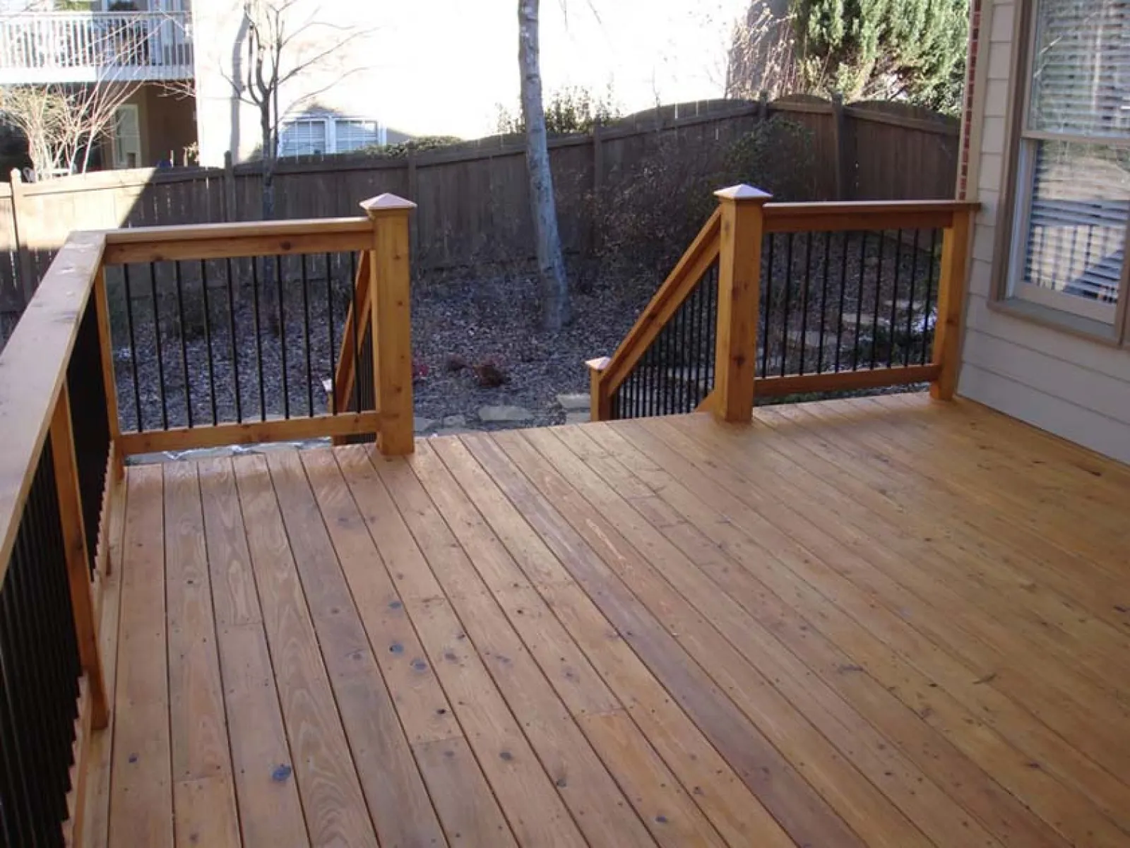 a deck with a wood railing