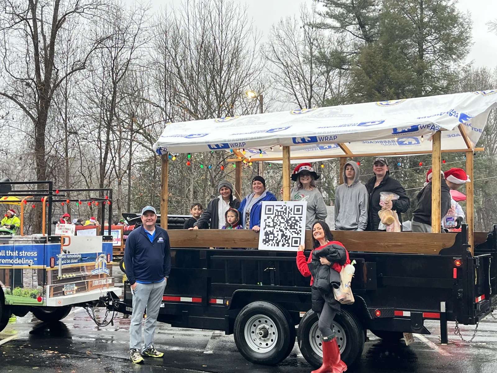 a group of people standing on a truck with a sign