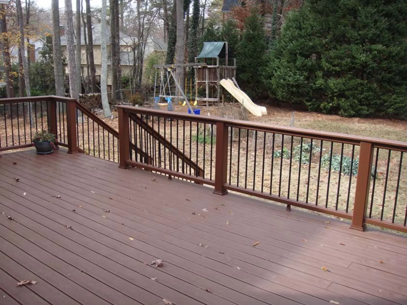 a deck with a slide and trees
