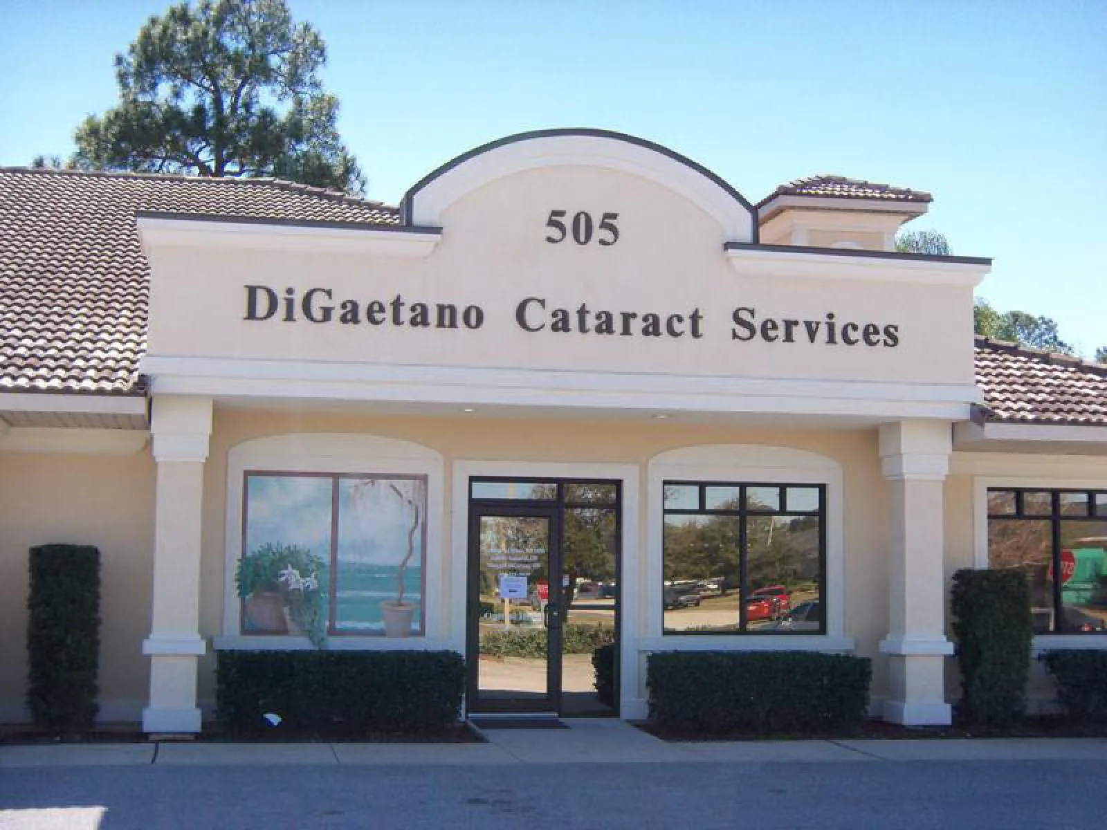 Front view of DiGaetano Cataract Services building with beige facade and large windows.