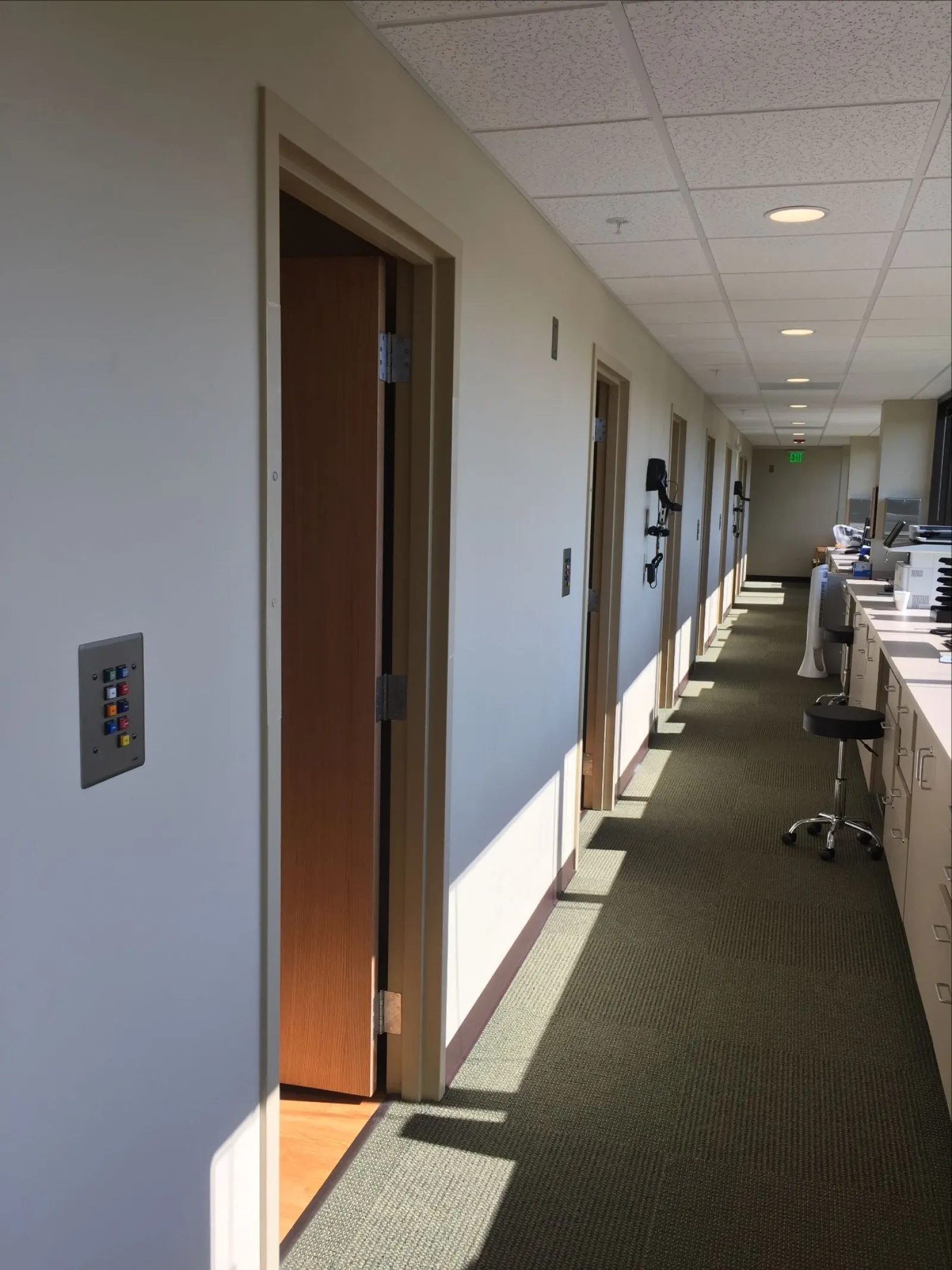 a hallway with a desk and chairs