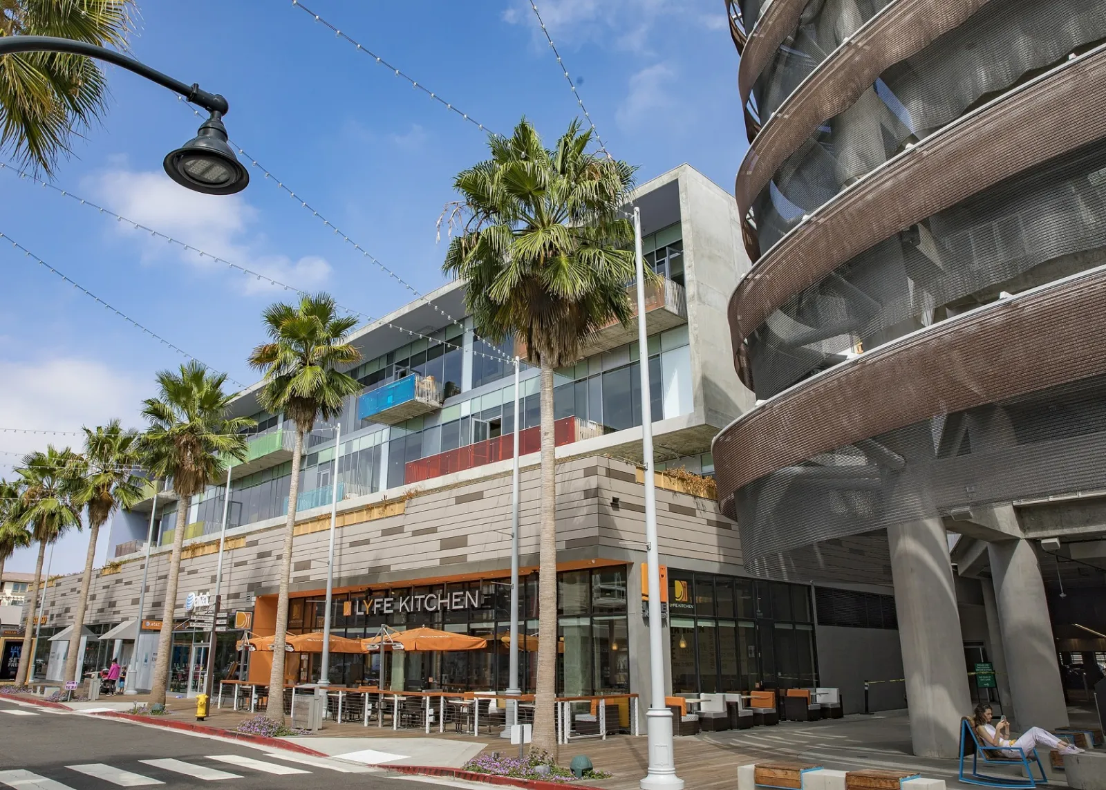 a building with palm trees and a street