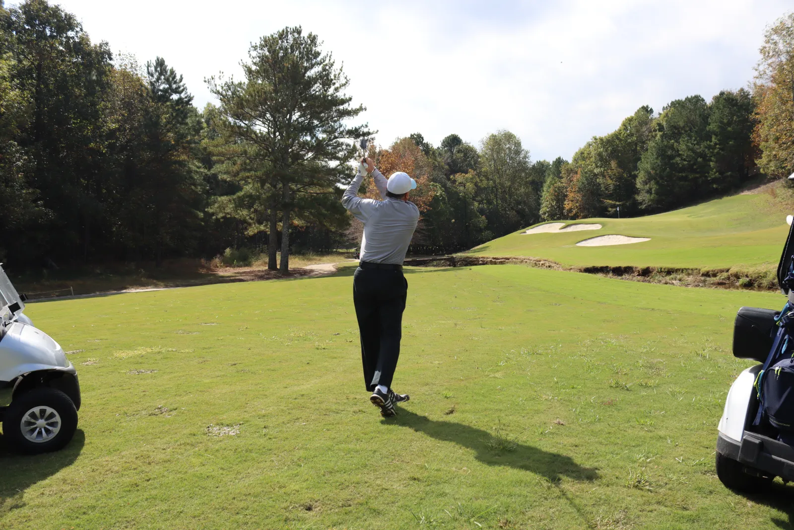 a person swinging a golf club