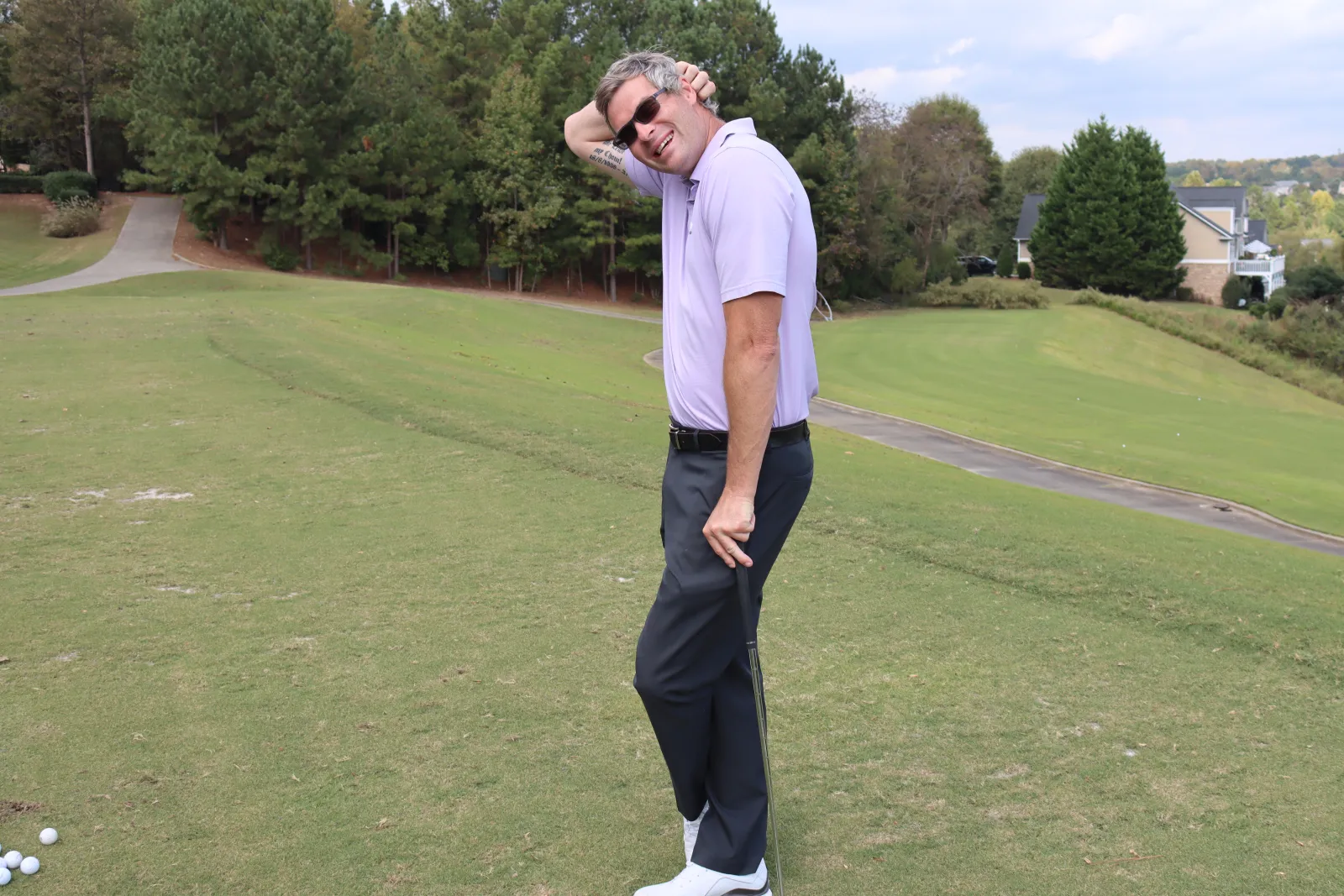 a man with sunglasses on a golf course