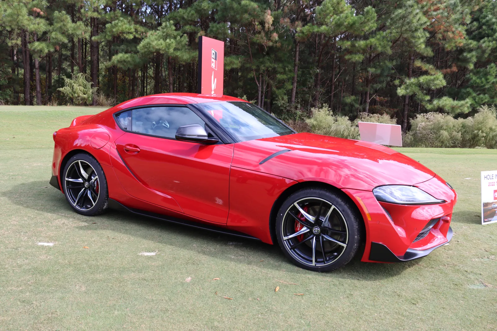 a red sports car parked on grass