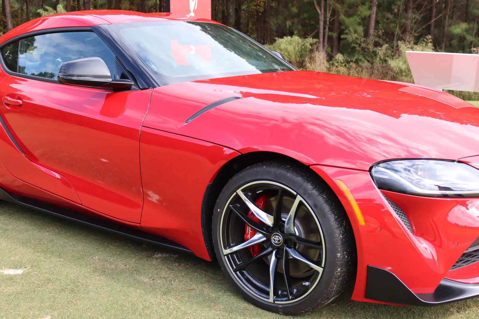 a red car parked on grass