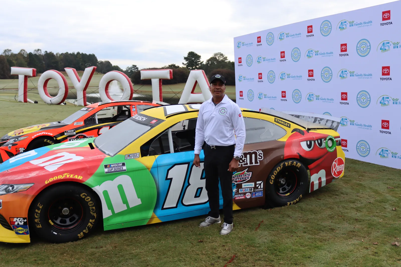 a person standing next to a race car