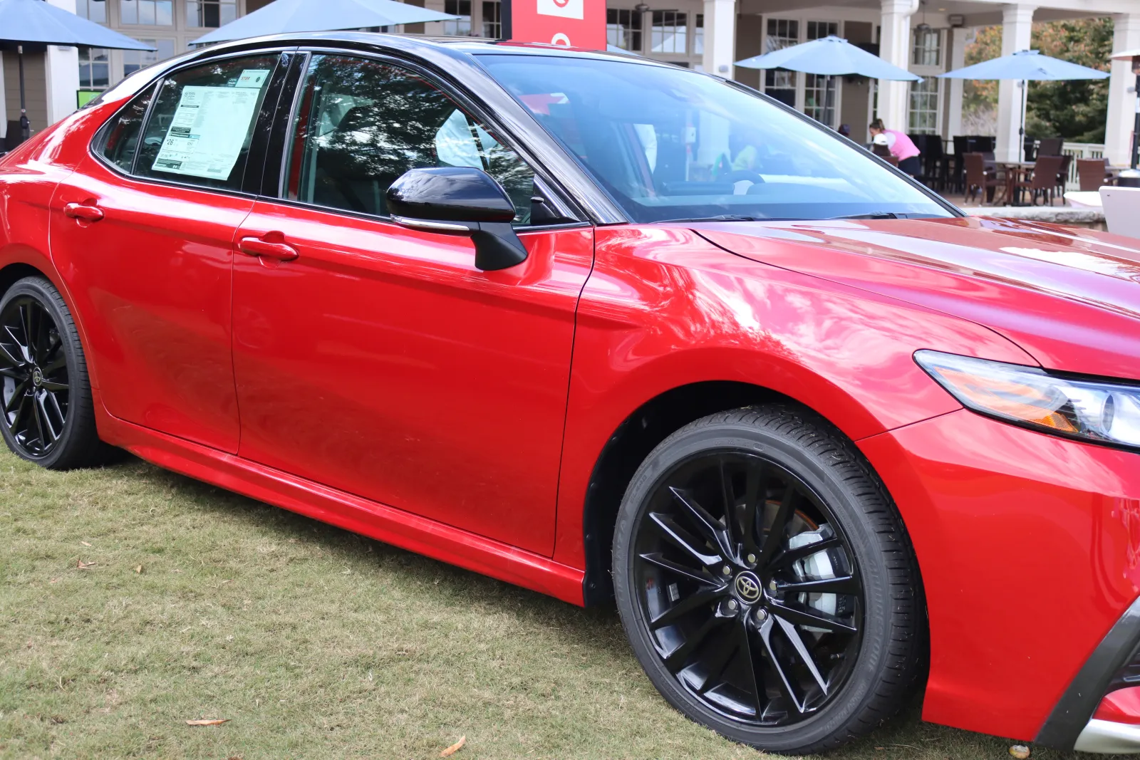 a red car parked on grass