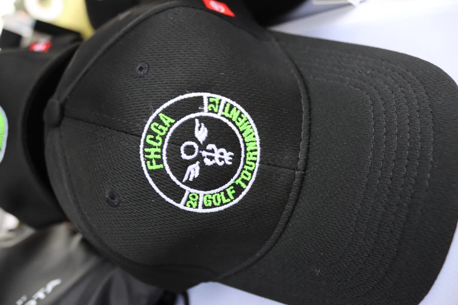 a black hat with a green logo