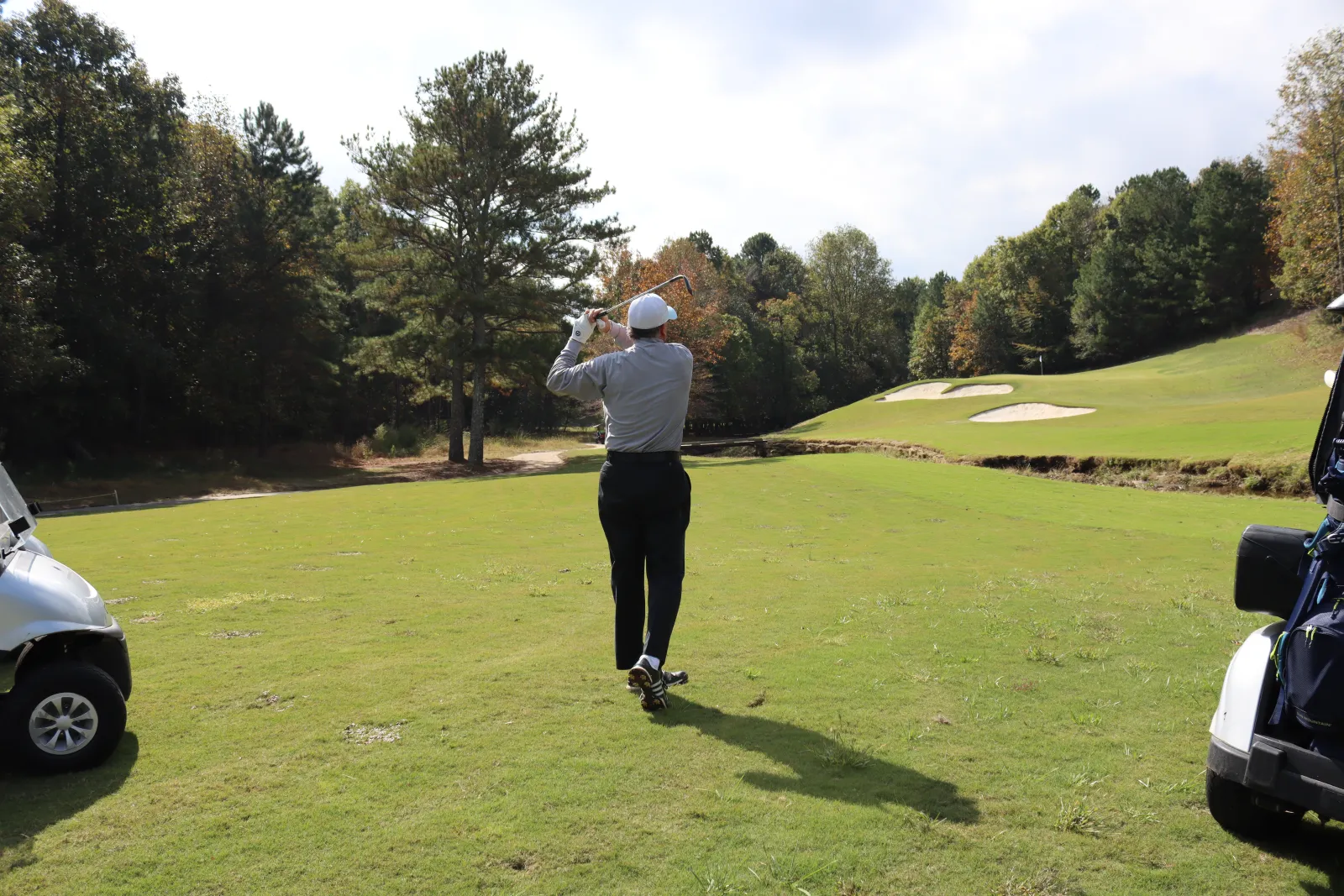 a person swinging a golf club