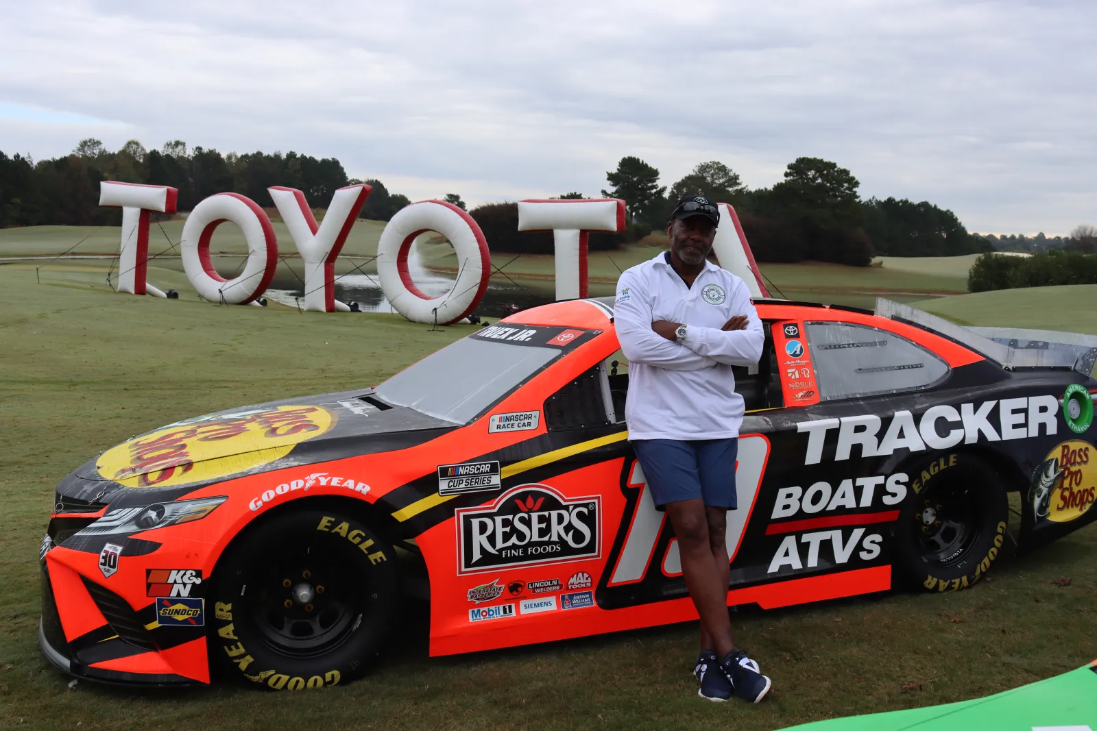 a person standing next to a race car