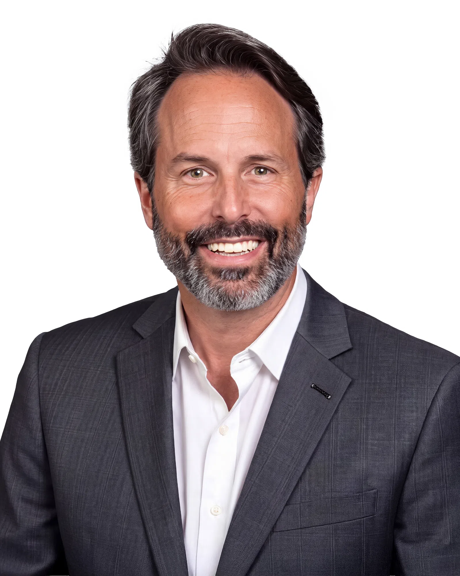 Smiling middle-aged man with salt-and-pepper beard wearing a dark suit jacket and white shirt against white background