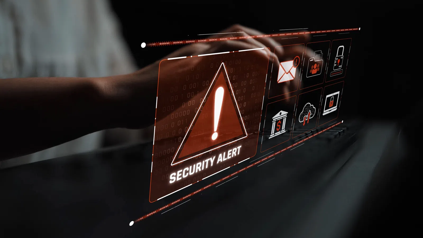 Hand interacting with digital screen displaying security alert and cyber protection icons in dark setting