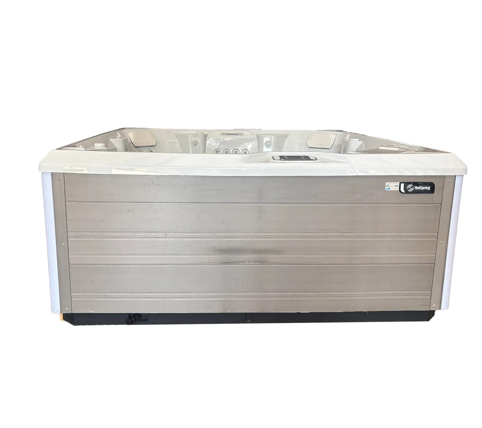 Modern rectangular hot tub with gray wooden panel exterior and white interior featuring jets and headrests.