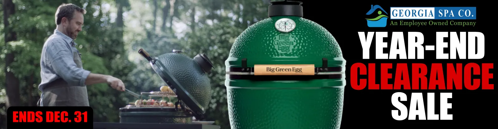 a person standing next to a green garbage can