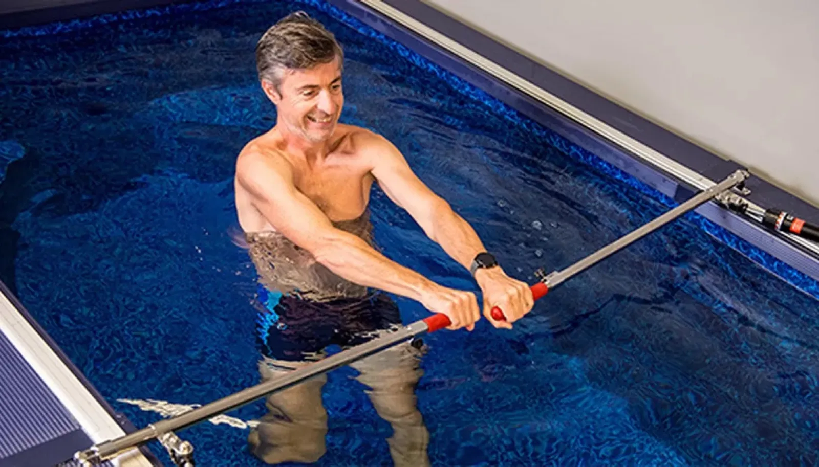 a man rowing in a pool