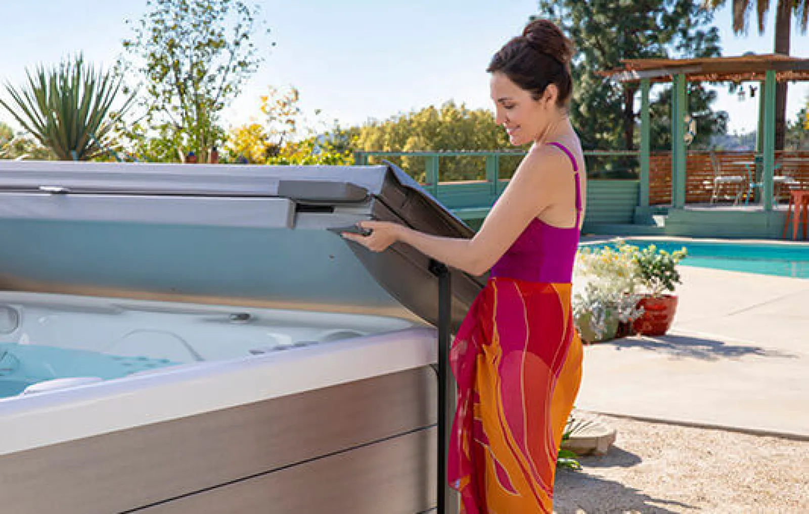 a woman holding a hot tub cover