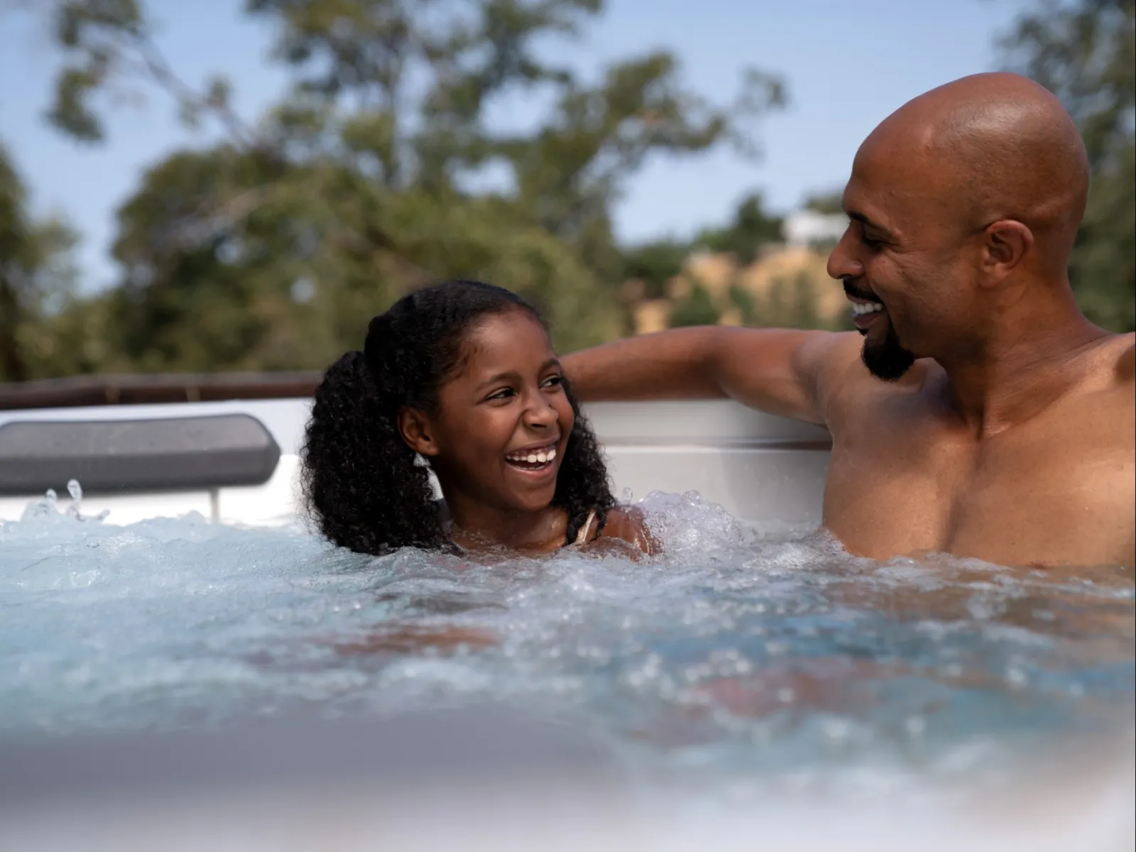 a man and a girl in a hot tub