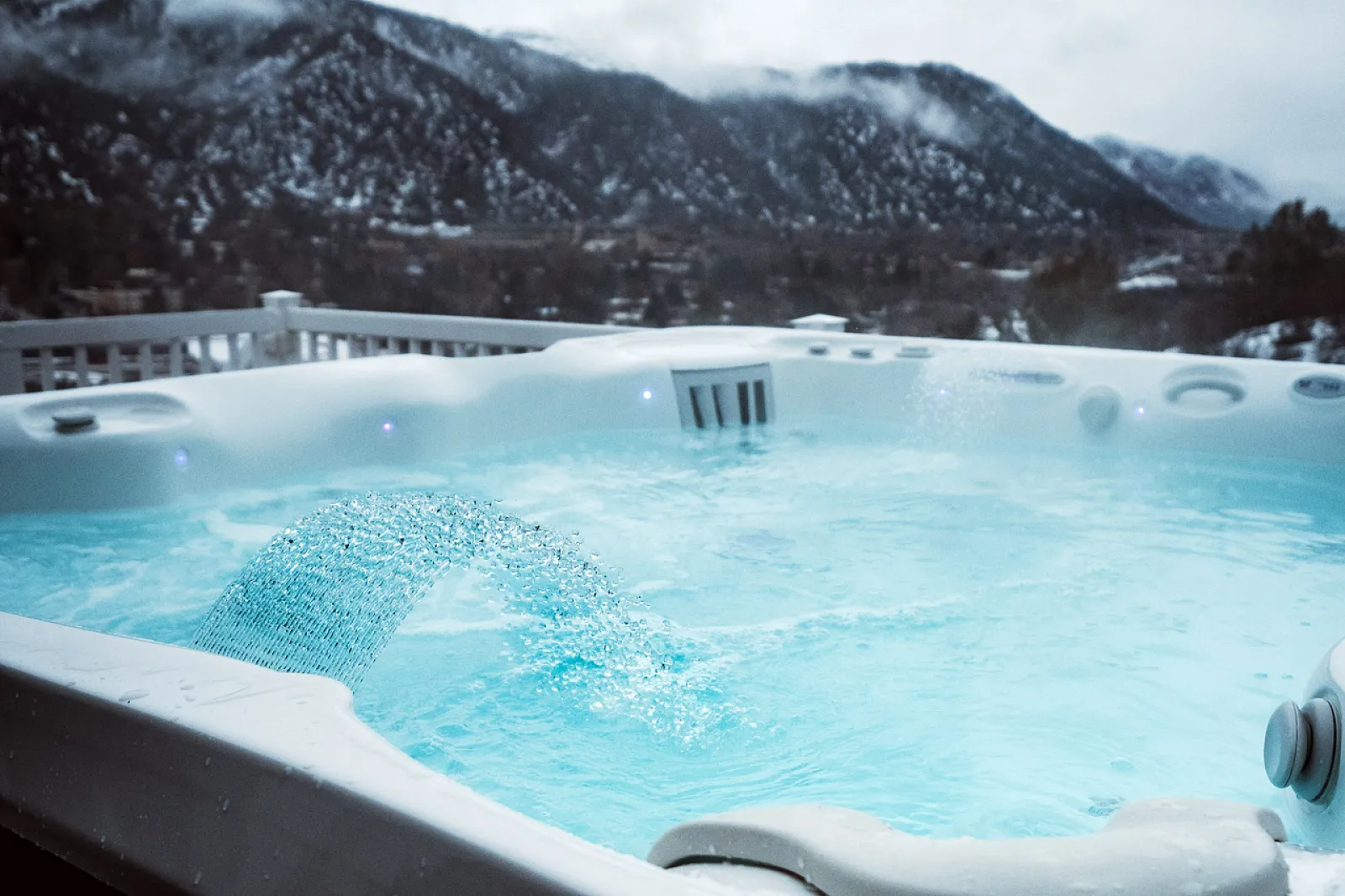 a large hot tub with a mountain in the background