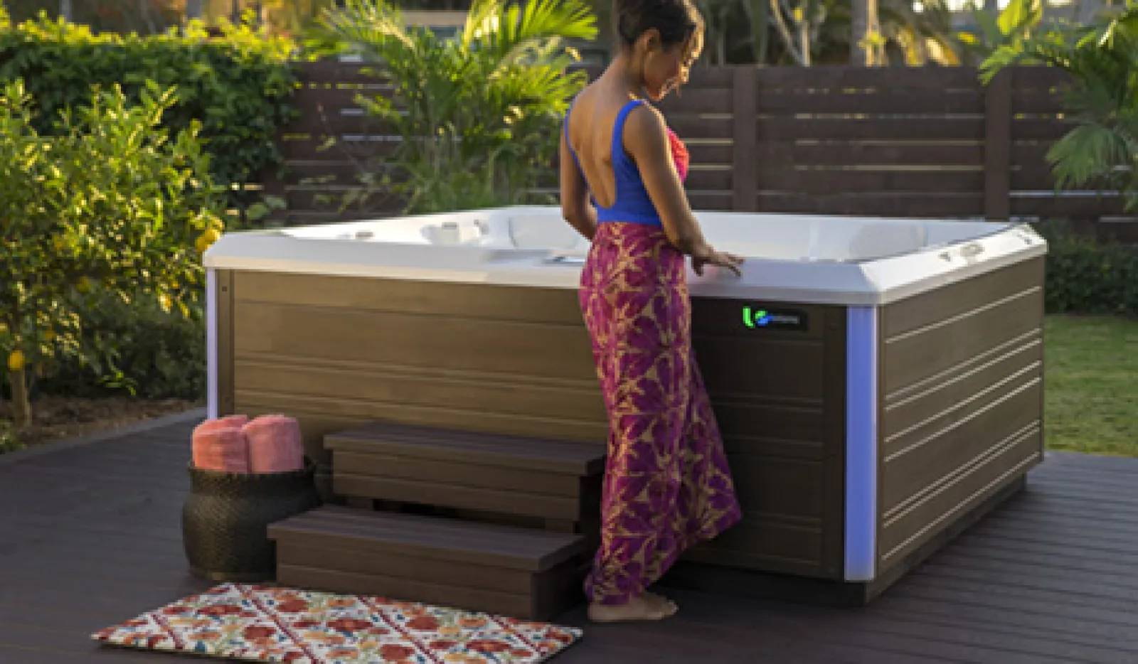 a woman standing next to a hot tub