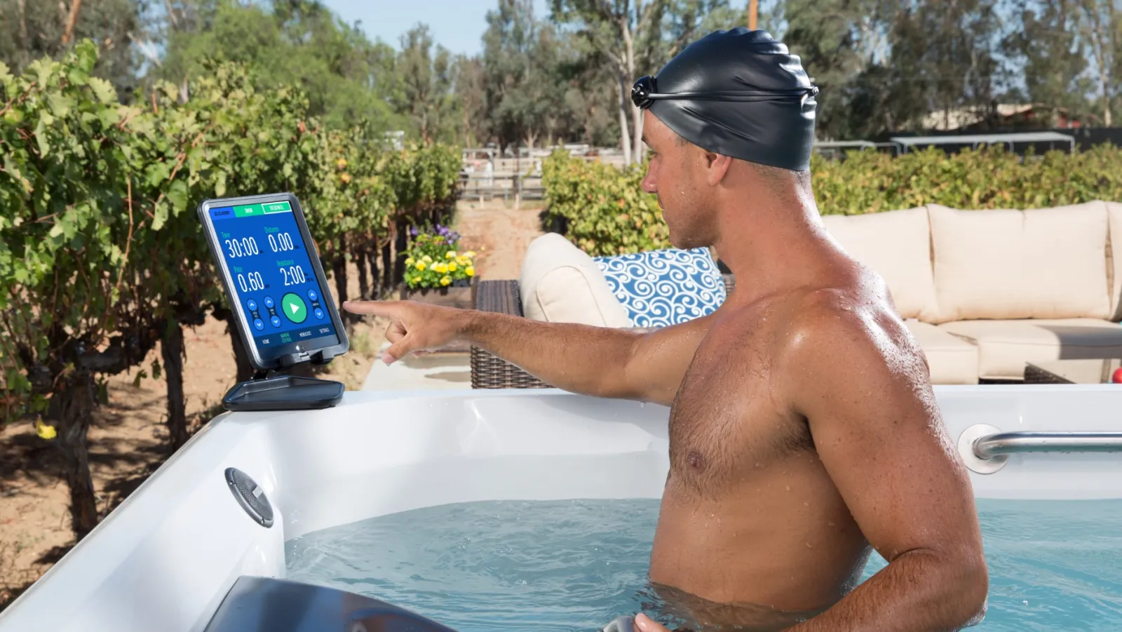 a man in a pool using a tablet