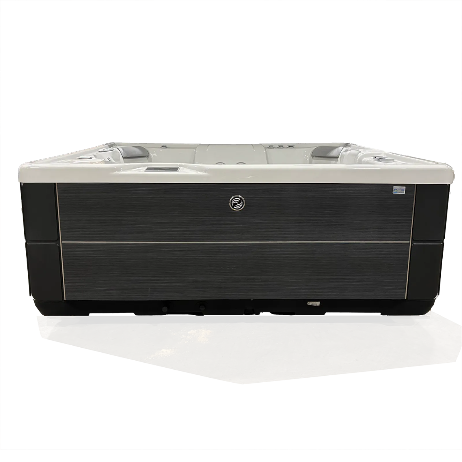 Modern outdoor hot tub with dark wood paneling and white interior seating in a rectangular shape.