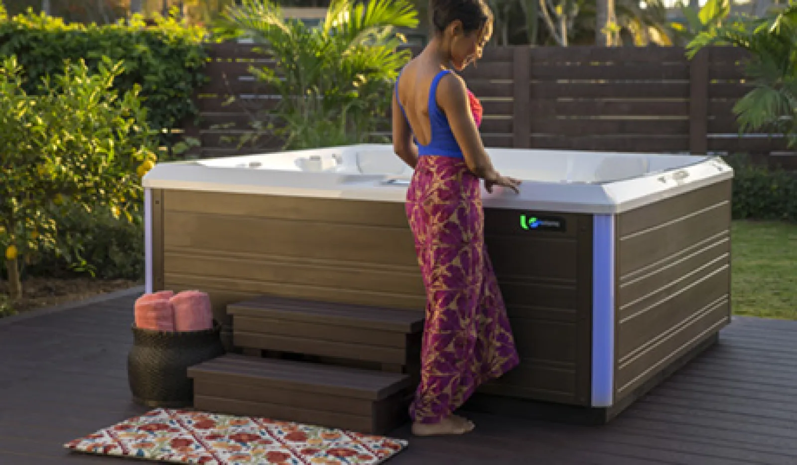 a woman in a swimsuit by the hot tub