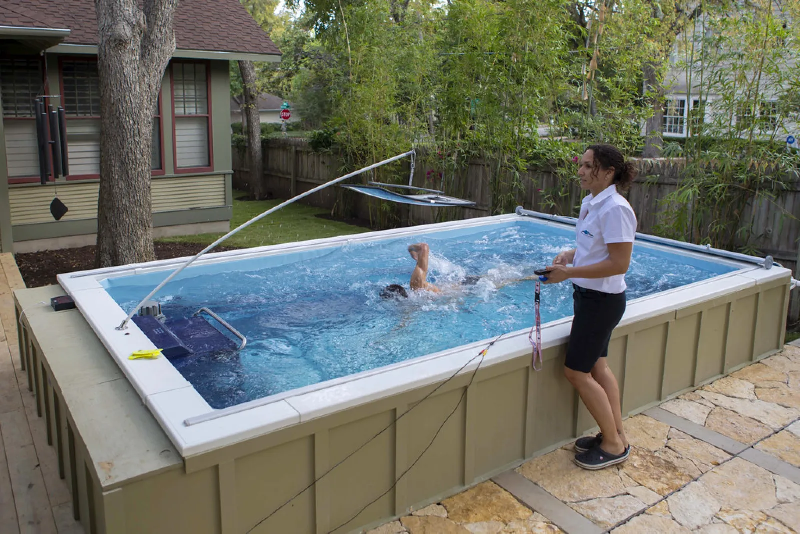 a person standing next to a pool