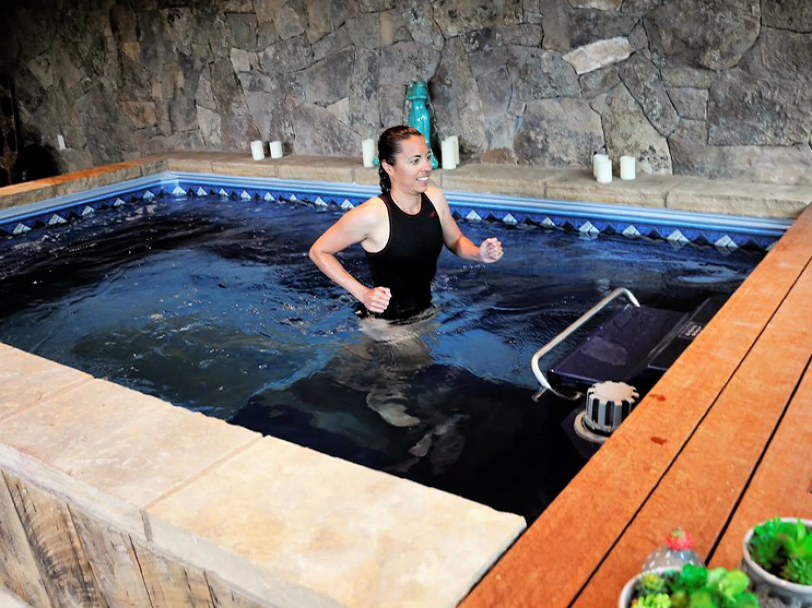 a person in a pool on a treadmill