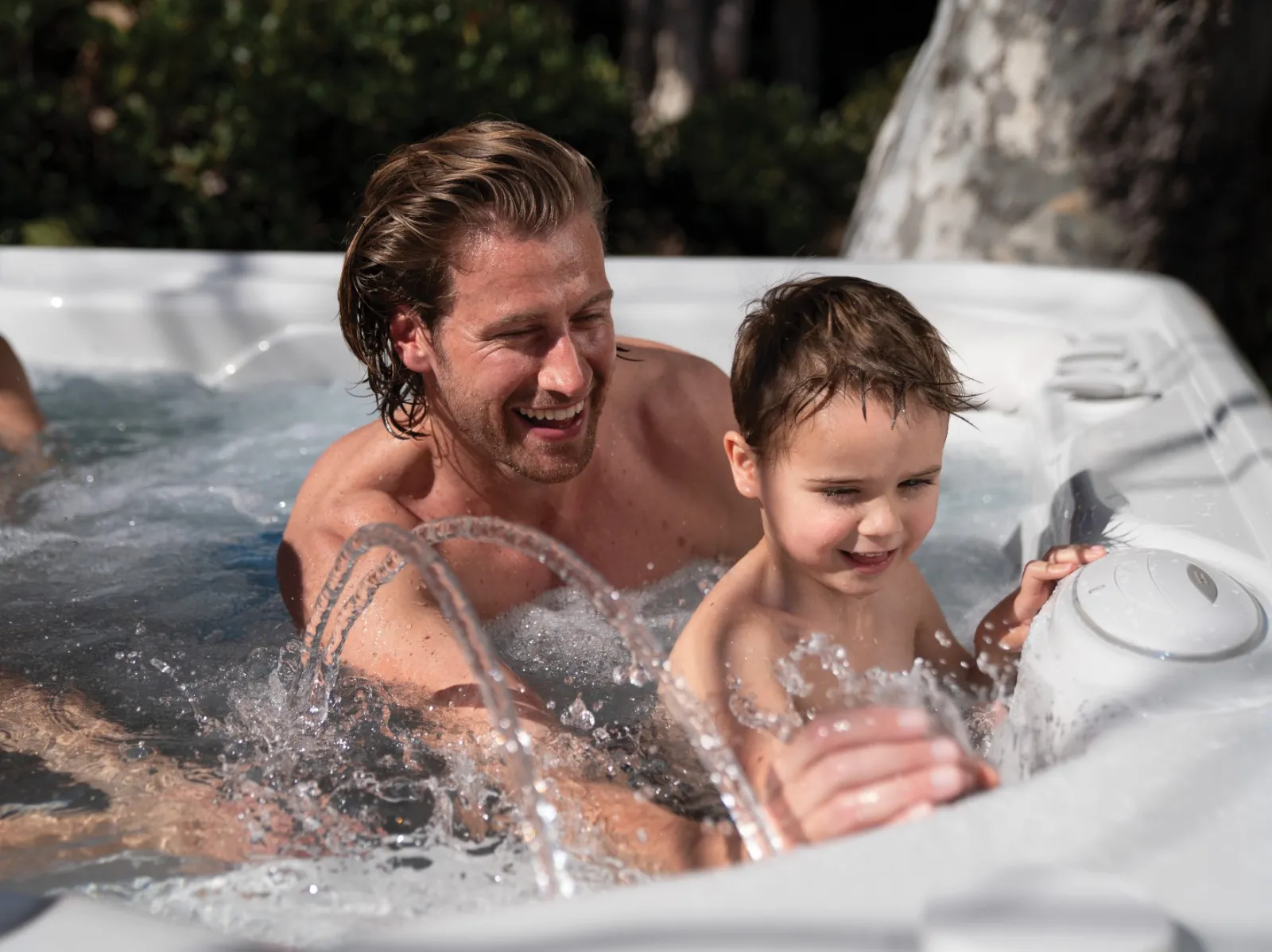 a person and a boy in a hot tub