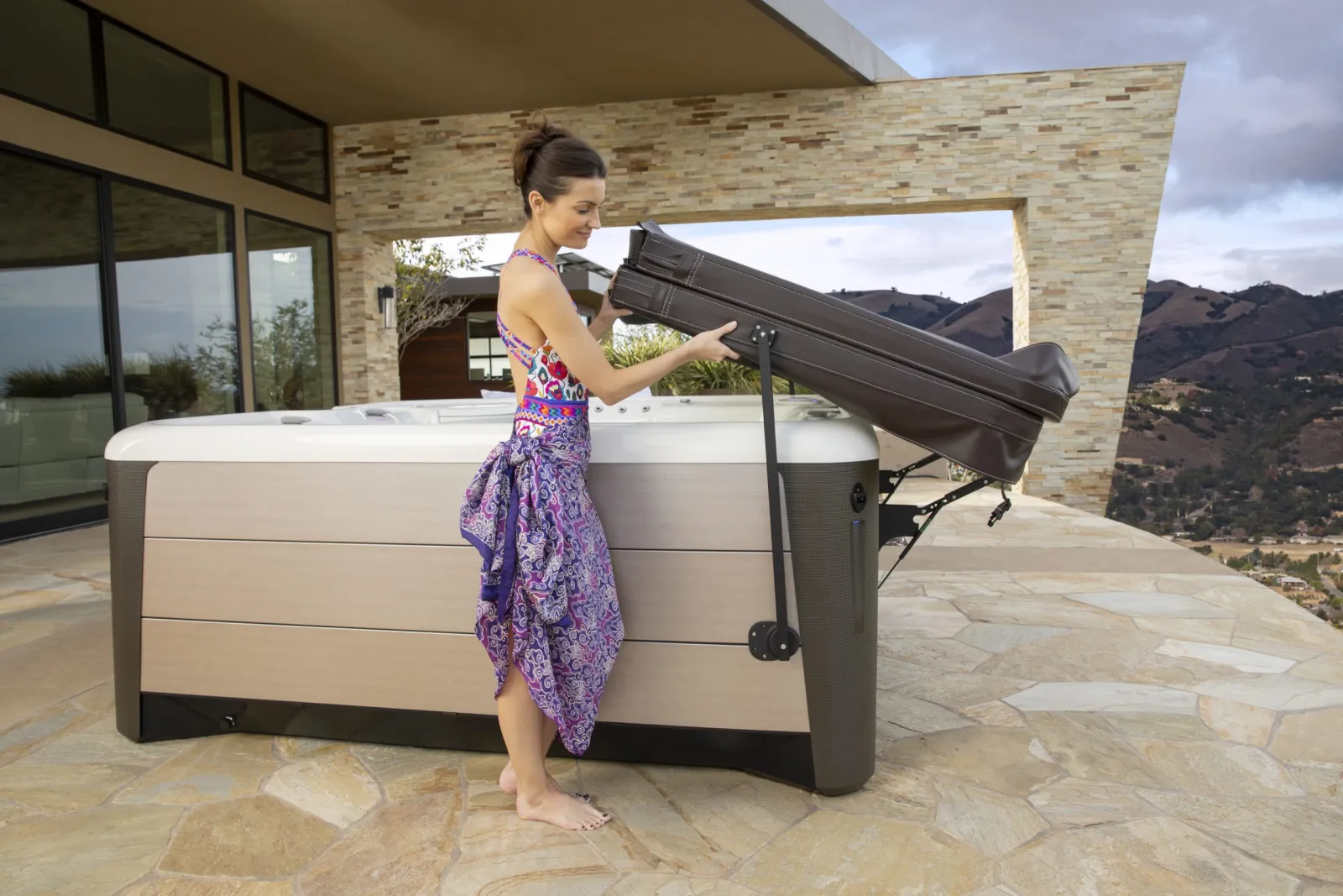 a person standing next to a hot tub