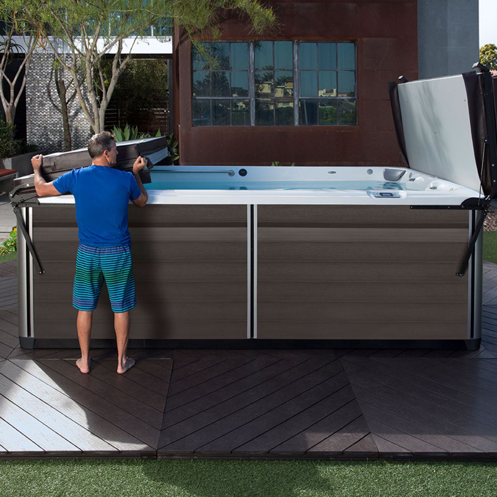 a man standing by a swim spa