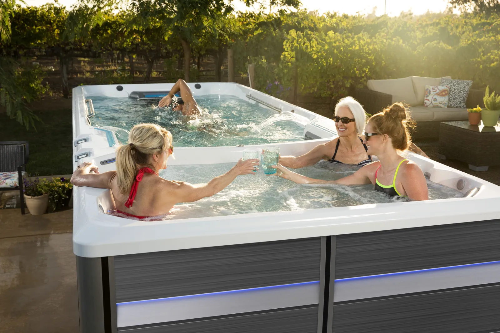 Group of people enjoying an Endless Pool swim spa.