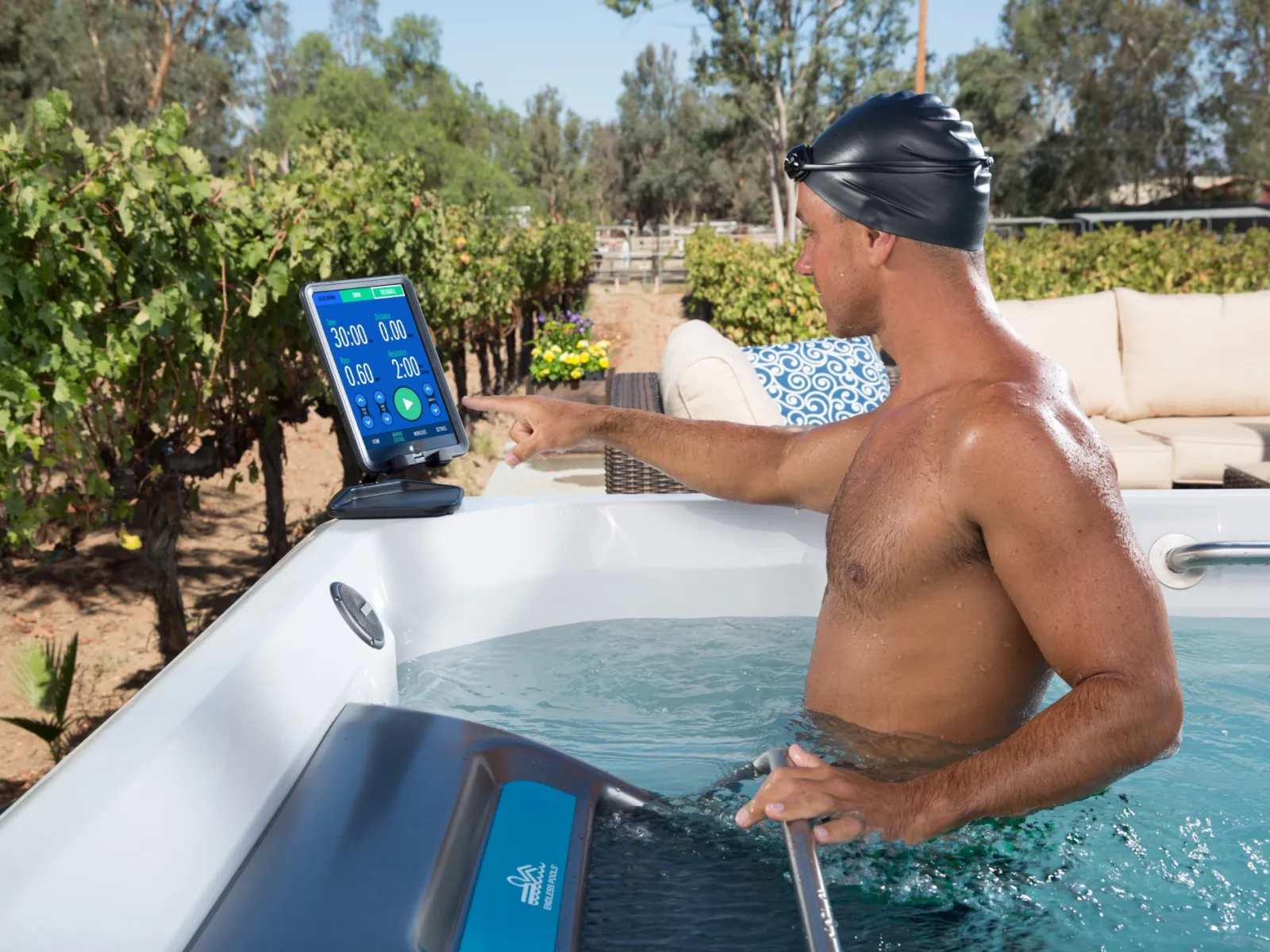 a man in a hot tub using a tablet