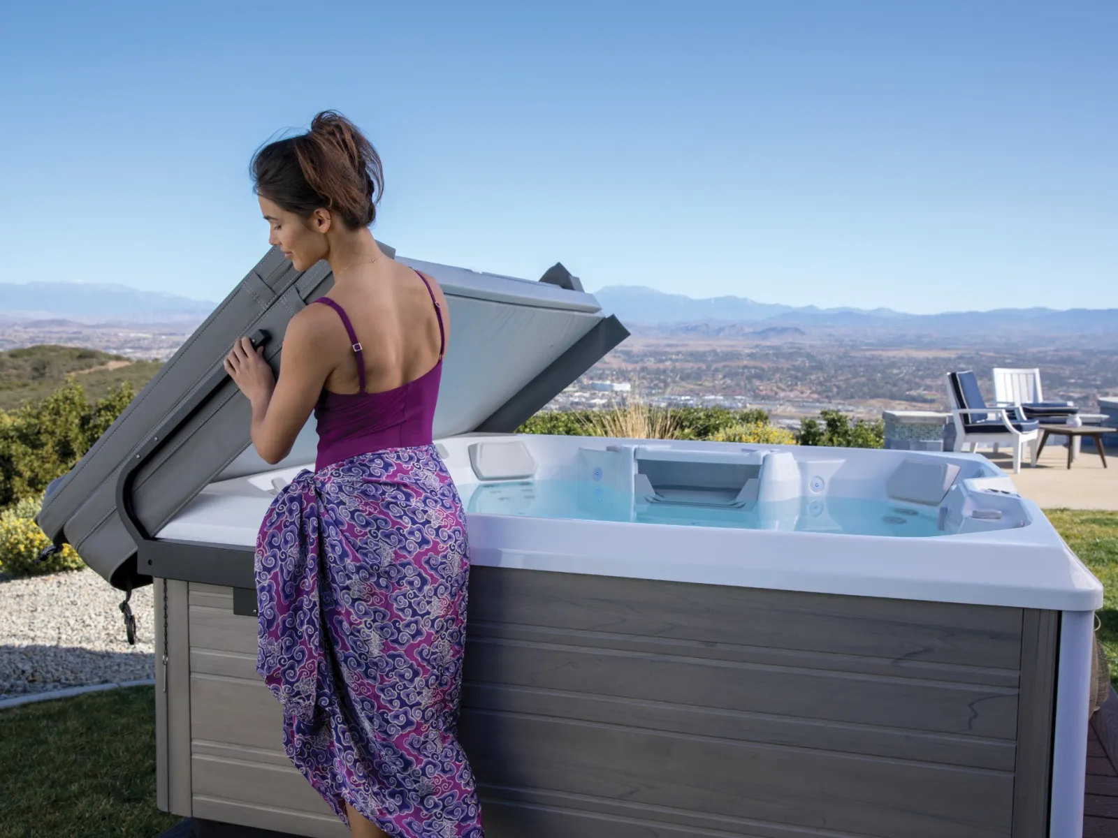 a woman in a swimsuit by the hot tub