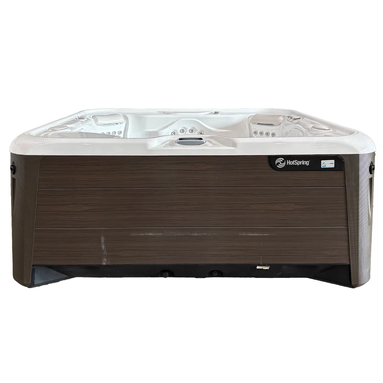Modern HotSpring hot tub with white interior, wood-paneled exterior, and multiple jet seating areas.