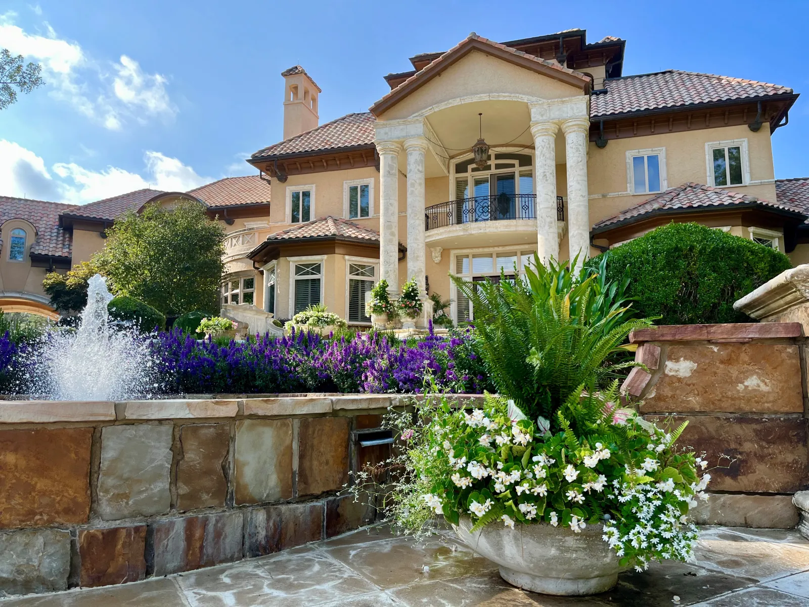 a house with a fountain in the front