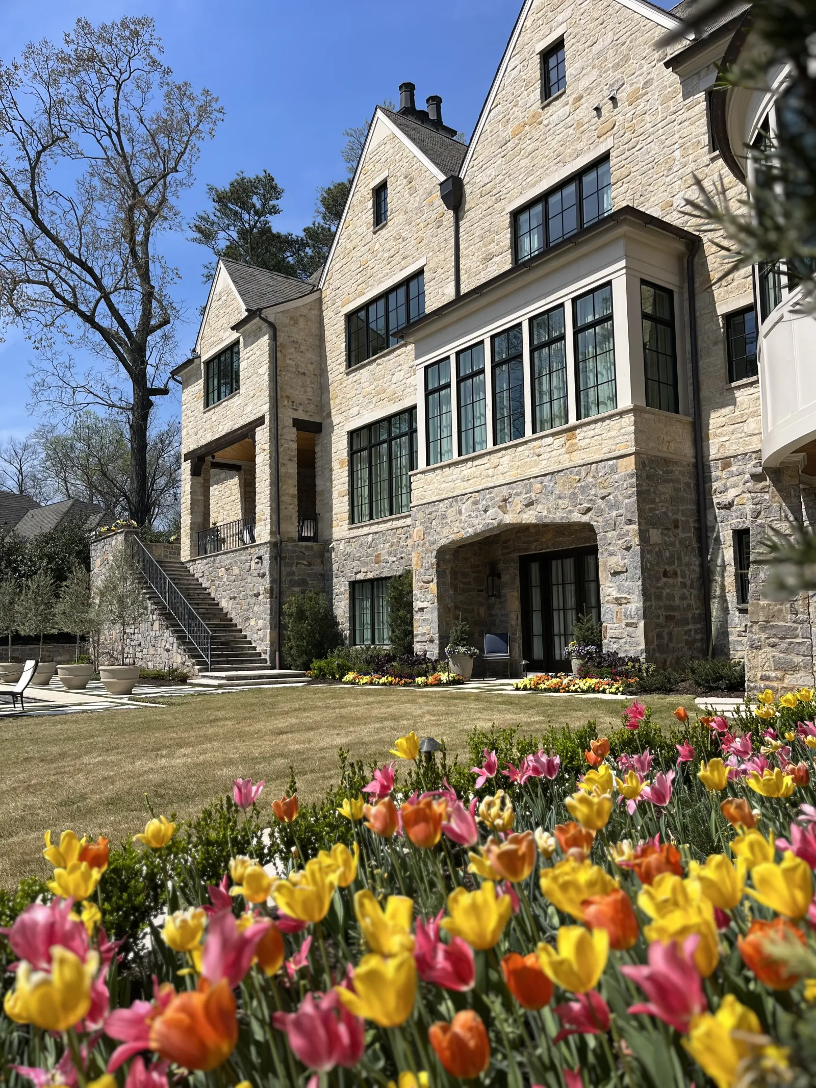 a large building with many flowers in front of it