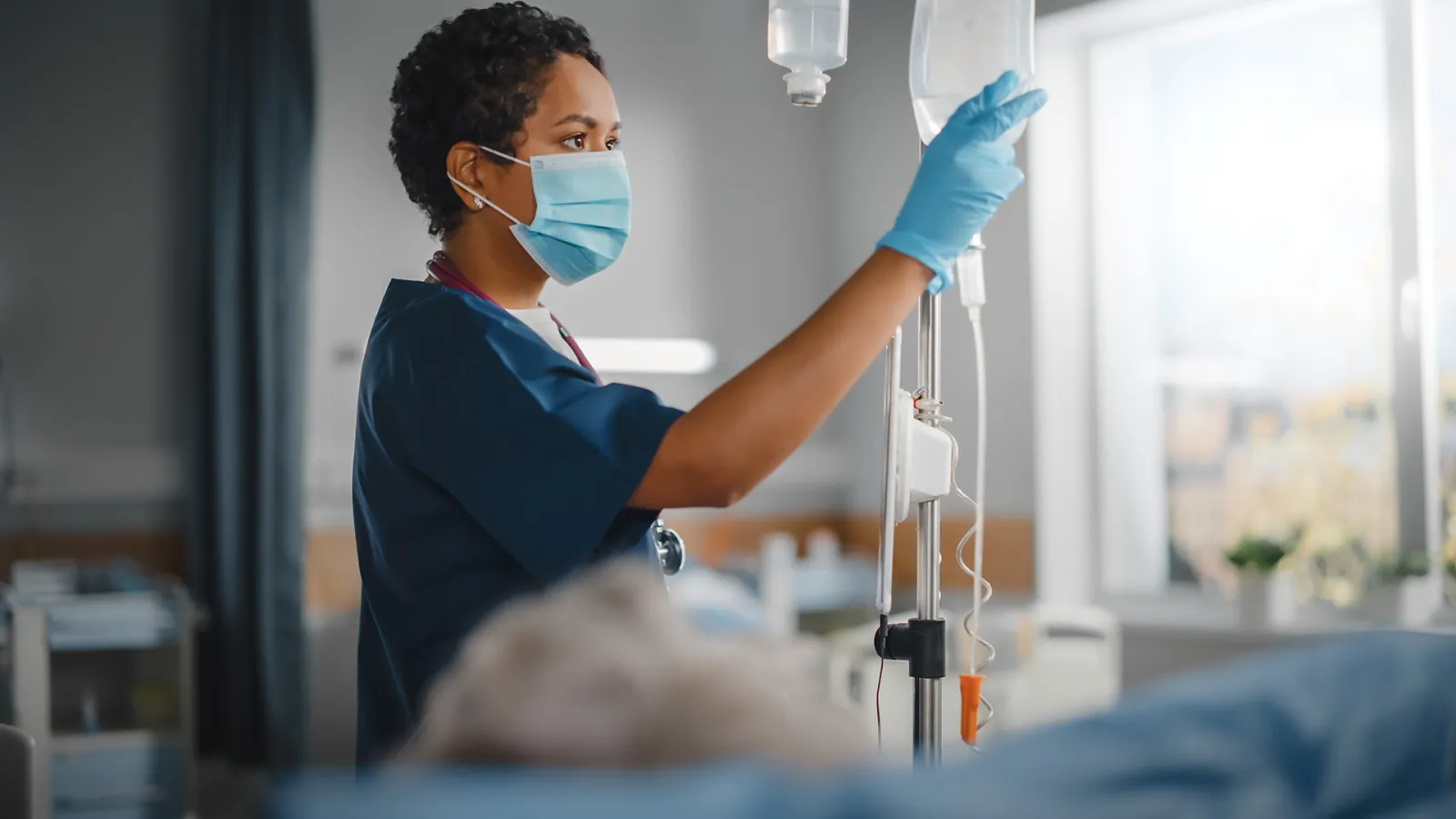 a nurse working in blue scrubs