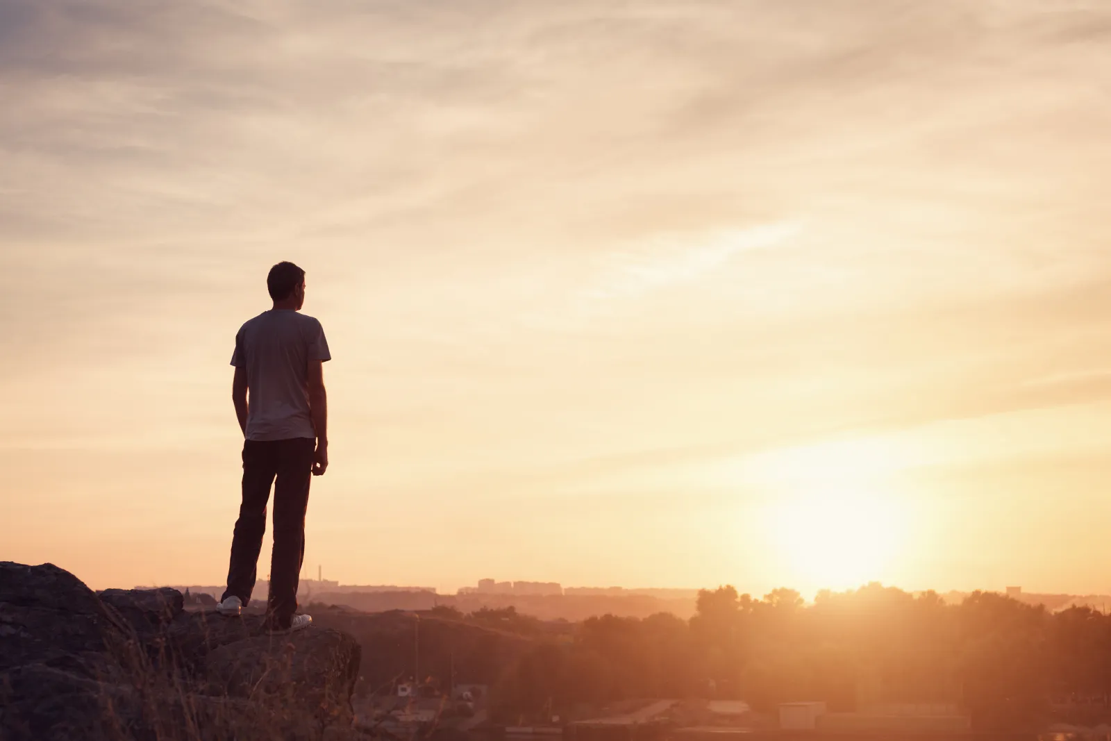 A man staring at a sunset