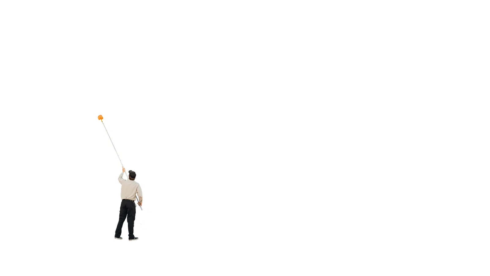 Man in business attire holding an oversized key and reaching upwards against a white background