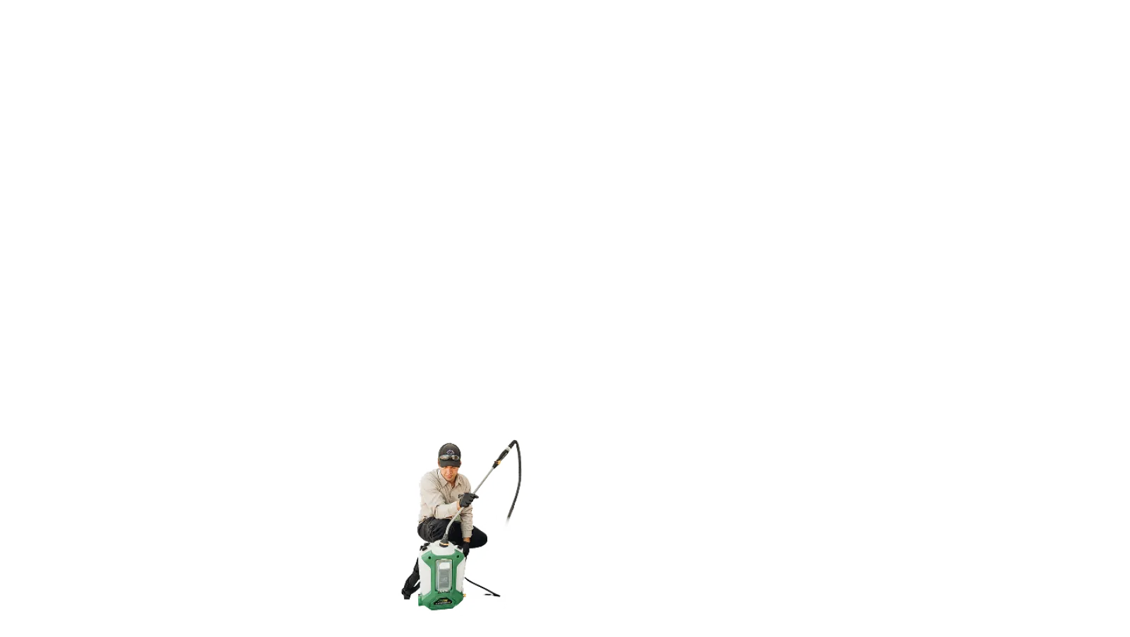 Man wearing hat and glasses fishing while sitting on a green tackle box with fishing rod in hand