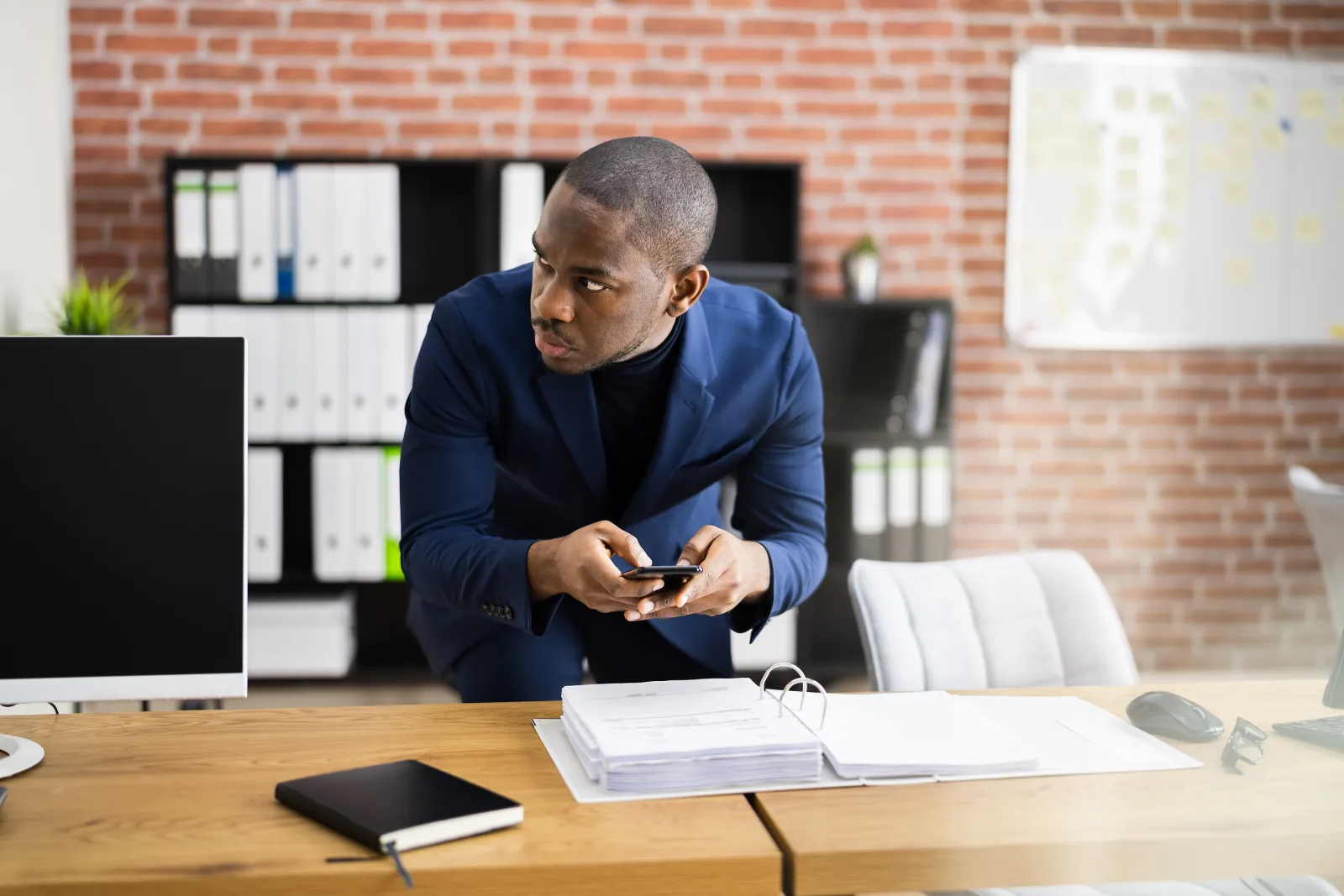 a man holding a phone suspiciously