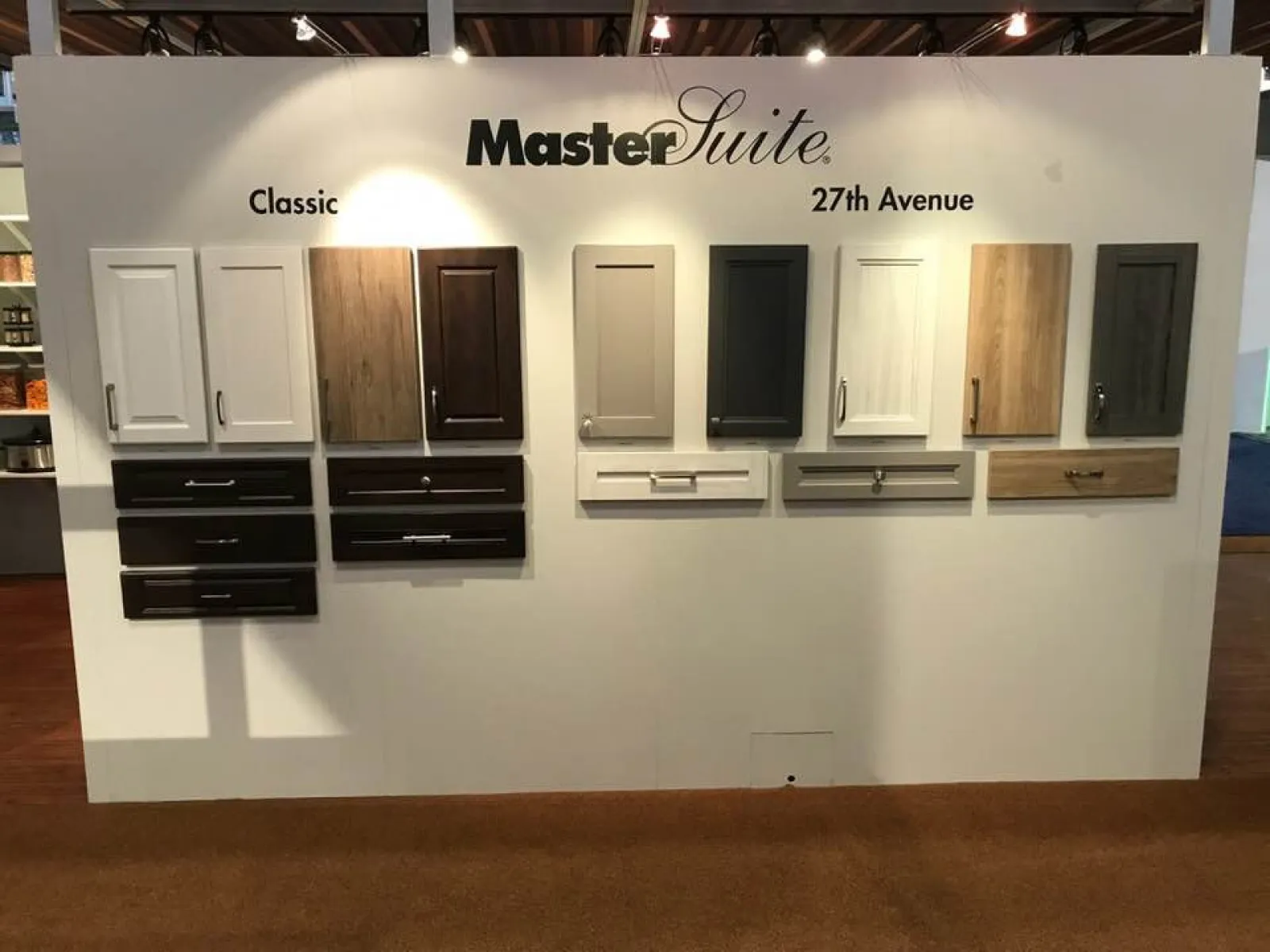 Display of MasterSuite cabinetry and drawer front styles in Classic and 27th Avenue collections on white board.