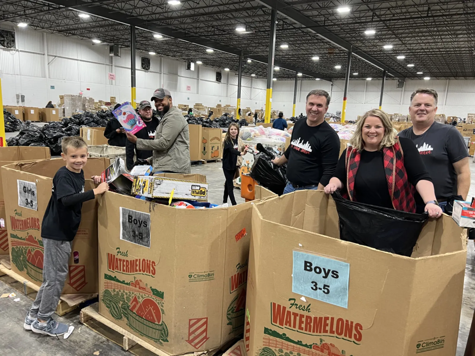 a group of people standing next to boxes